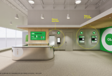 Reception area with express return and unit return kiosks in a modern lobby, near an information desk and branding signage on the wall