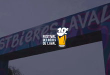 Archway banner announcing the 10th Festival des Bières de Laval, with a beer glass logo in the center.
