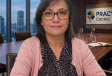 Professional woman with glasses seated at a conference table in a meeting room, PRACT Conseil sign in background.