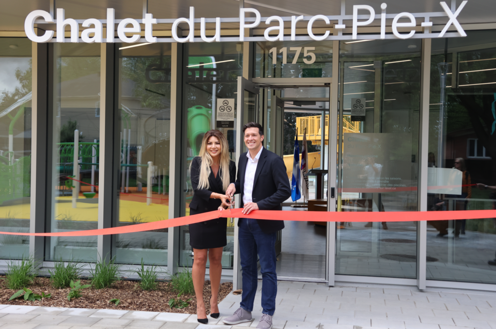 Man and woman in business attire cutting a red ribbon in front of the Chalet du Parc-Pie-X storefront during a grand opening; 1175 sign visible above the entrance.