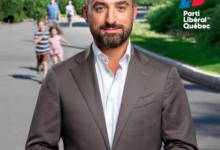 Portrait of a man in a gray suit facing the camera in an outdoor park setting, with the Parti Libéral du Québec logo visible on the right.